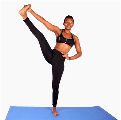 Fit athletic woman stretching leg while standing