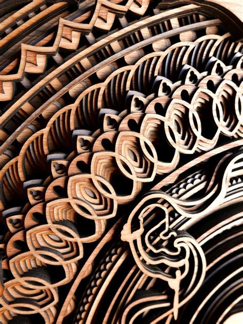 Layers of intricate patterns are featured in mesmerising laser-cut wood sculptures ...