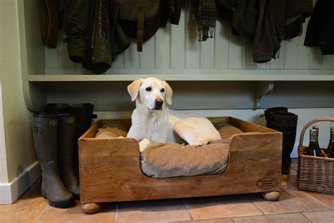 Pine deep sided raised dog bed. Handmade in England. In utility room of country house Raised ...