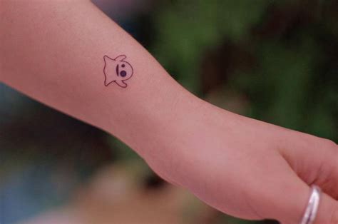 Tiny ghost tattoo done on the wrist, minimalistic