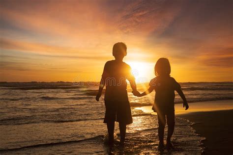 Silhouette Of Young Children Holding Hands At Sunset Stock Photo - Image of outside, love: 40354234