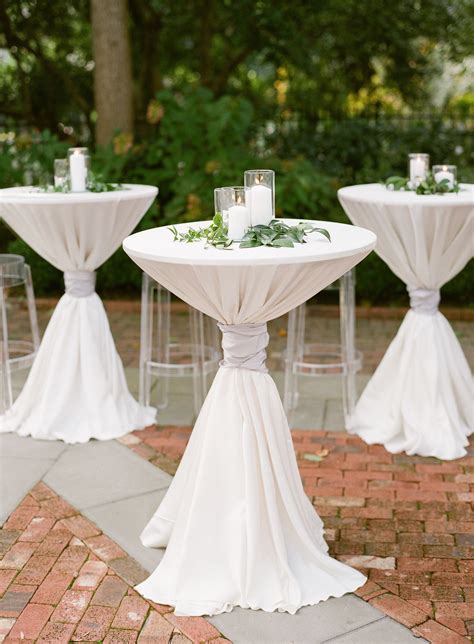 White Pillar Candles and Greenery Atop Cocktail Tables | Wedding ...