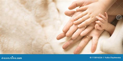 Newborn Child Hand. Closeup of Baby Hand into Parents Hands. Family ...