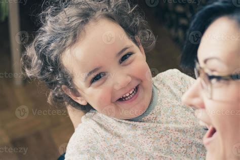 Happy little girl laughing while spending time with her mother. 11400911 Stock Photo at Vecteezy