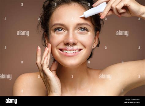 Woman appling cream hi-res stock photography and images - Alamy