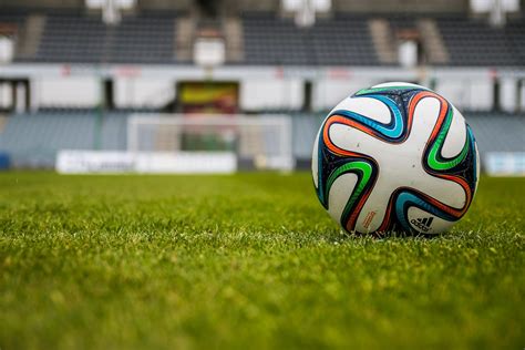 Blue Orange Black Green White Adidas Soccer Ball on Green Field · Free Stock Photo