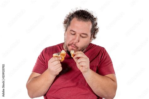 Funny fat man eating small croissant on white background. Good morning ...