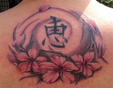 Chinese tattoo with cherry blossom and symbol on back - Tattooimages.biz