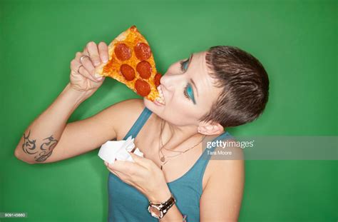 Woman Eating Pizza Slice High-Res Stock Photo - Getty Images
