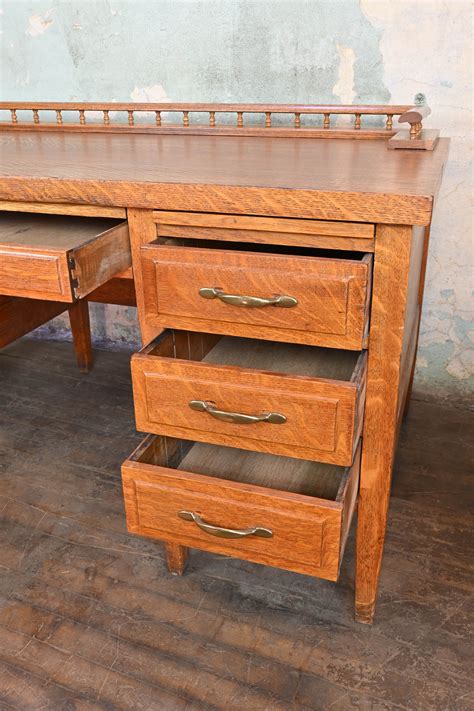 tiger oak 7 drawer desk with top rail — ARCHITECTURAL ANTIQUES