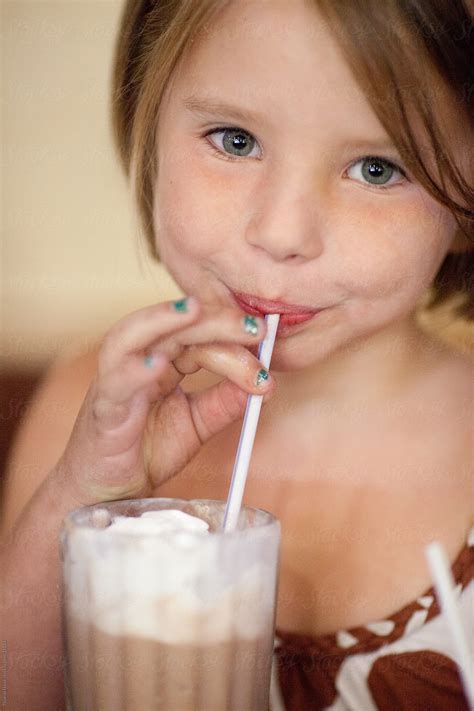 "Girl Drinking Chocolate Milkshake" by Stocksy Contributor "Thomas Hawk" - Stocksy