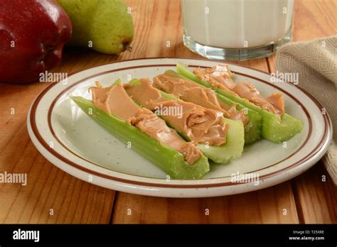 Celery sticks stuffed with organic creamy peanut butter Stock Photo - Alamy