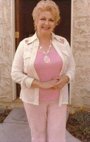 an older woman in pink pants and white jacket