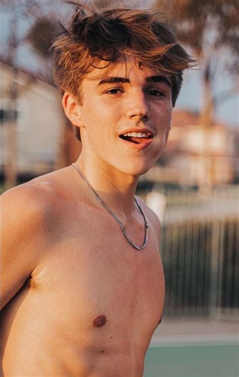 a shirtless young man holding a tennis racquet