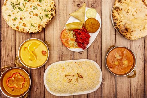Set of Typical Indian Food Dishes with Cheese Garlic Naan, Biryani Rice, Different Sweet and ...