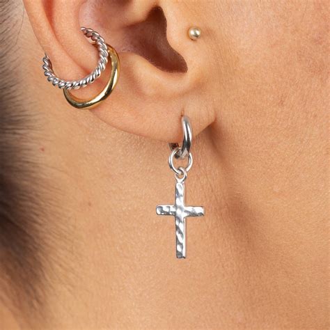 silver cross huggie hoop earring, single earring by scream pretty | notonthehighstreet.com