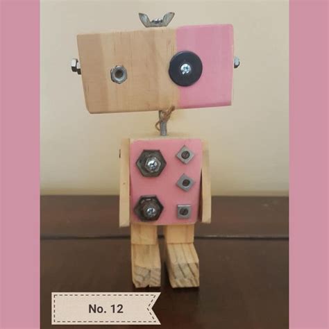 a wooden toy with buttons attached to it's body on a brown table next to a sign that says no 12