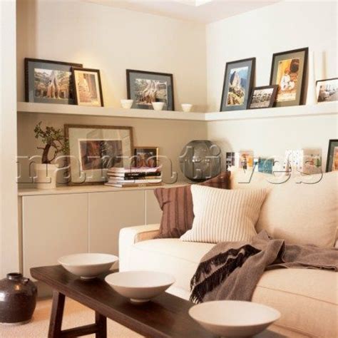 Living room corner in cream tones with built in cupboard and shelves ...