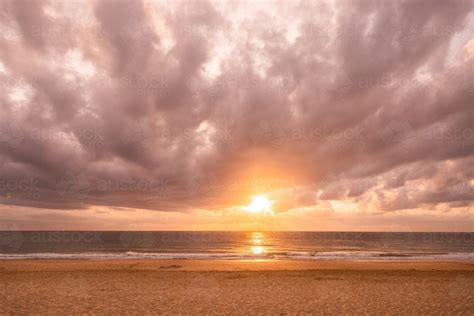 Image of Dawn at the Beach with golden sunlight - Austockphoto