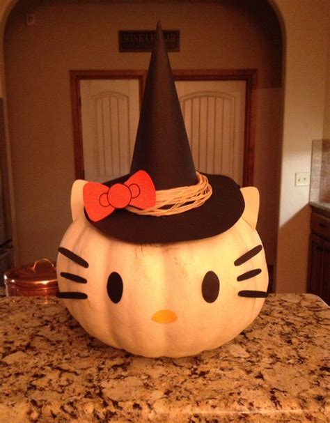 a hello kitty pumpkin sitting on top of a kitchen counter with a black ...