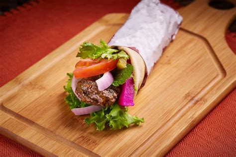 Premium Photo | Spicy arabian kabab shawarma wrap with salad served in ...