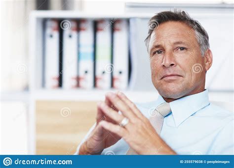 Contemplating Your Business Proposal. Portrait of a Respected Business Manager Sitting at His ...