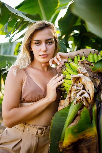 Premium Photo | Woman near large green leaf of banana tree on nature in park. tropical plants