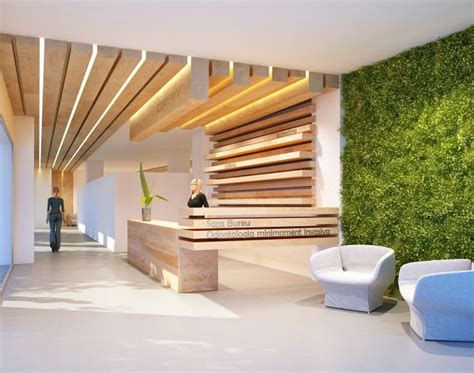 an office lobby with green walls and white chairs in front of the reception desks