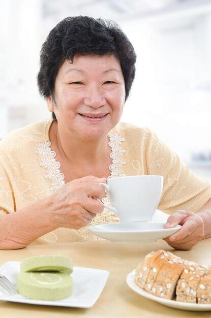 Premium Photo | Portrait of smiling woman with coffee at table