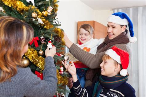 Ordinary Family Decorating Christmas Tree Stock Photo - Image of interior, children: 78104458