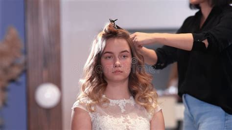 Girl Hairdresser Doing Hairstyle in the Form of Spinning Hair. Stock Image - Image of ...