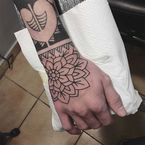 Outline flower tattoo on the right hand - Tattoogrid.net