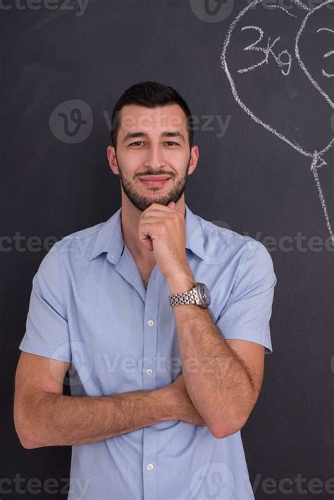 portrait of man in front of black chalkboard 31048597 Stock Photo at Vecteezy