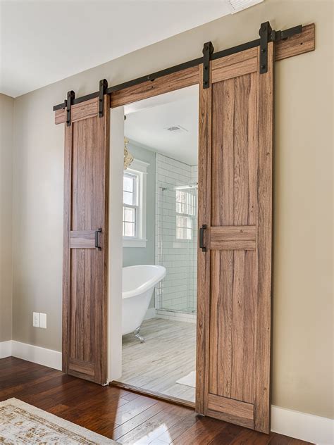 Barn doors leading into master bathroom in a modern farmhouse | Barn style sliding doors ...