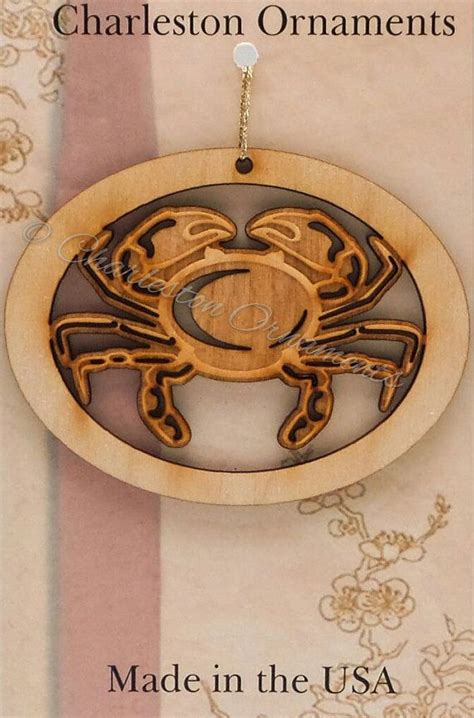 a wooden ornament with an image of a crab on it's side