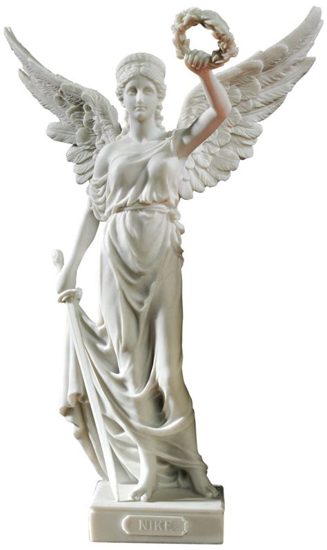 an angel statue holding a wreath in its hand and standing on a white ...