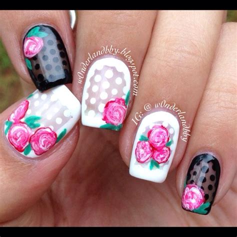 Cute girly nail art! Black & white sheer bases with polka dots n some swirly roses! Looove it ...