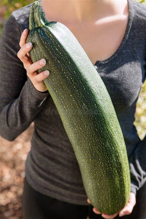 Woman is Holding a Big Giant Zucchini or Courgette in the Garden Stock Image - Image of giant ...