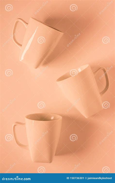 3 Orange Coffee Mugs on Orange Background Scattered with Empty ...