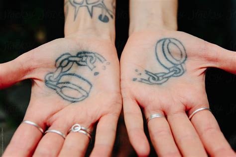 "A Tattoo Of Broken Handcuffs On The Palms Of Two Hands" by Stocksy ...