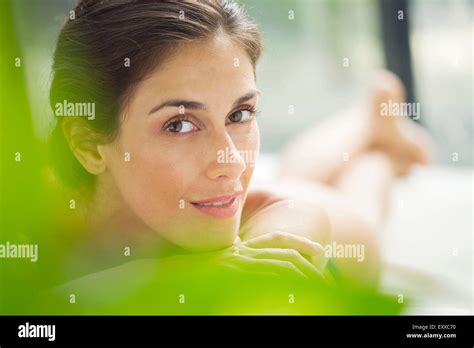 Woman relaxing on lounge chair Stock Photo - Alamy