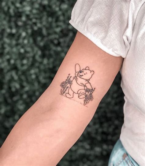 Fine line Pooh Bear tattoo on the inner arm