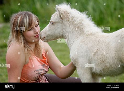 woman and Miniature Shetland Pony foal Stock Photo - Alamy