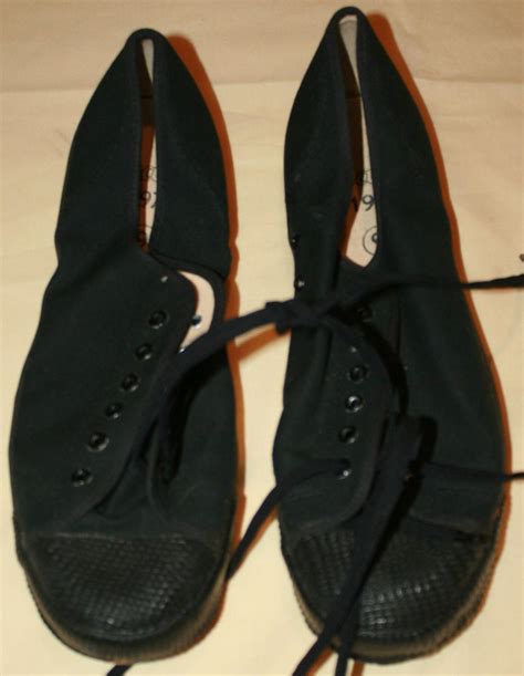 A MINT PAIR OF 1970 DATED BLACK PLIMSOLLS