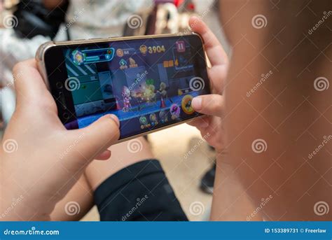 Kid playing a mobile game editorial photo. Image of game - 153389731