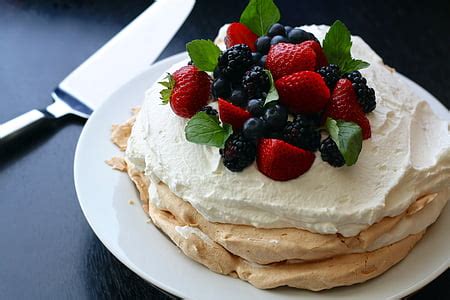 Royalty-Free photo: Strawberry cake on white plate near stainless steel cake server | PickPik