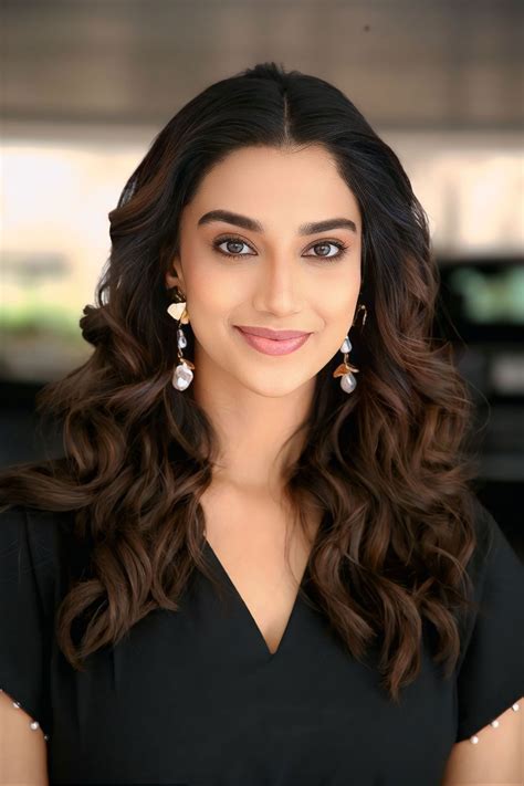 Meenakshi Chaudhary in Black Midi Dress for Anaganaga Oka Raju Interview