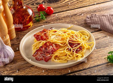 Italian classic spaghetti carbonara with fried bacon and egg Stock