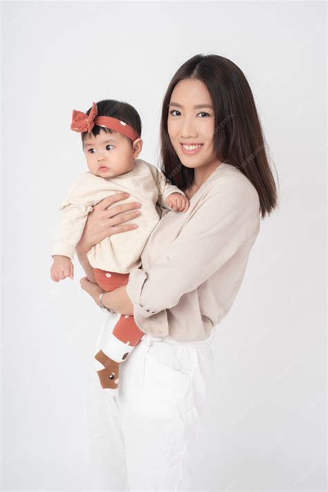 Premium Photo | Asian mother and adorable baby girl are happy on white wall