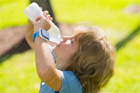 Premium Photo | Cute kid drinking fresh water little kid boy holds ...